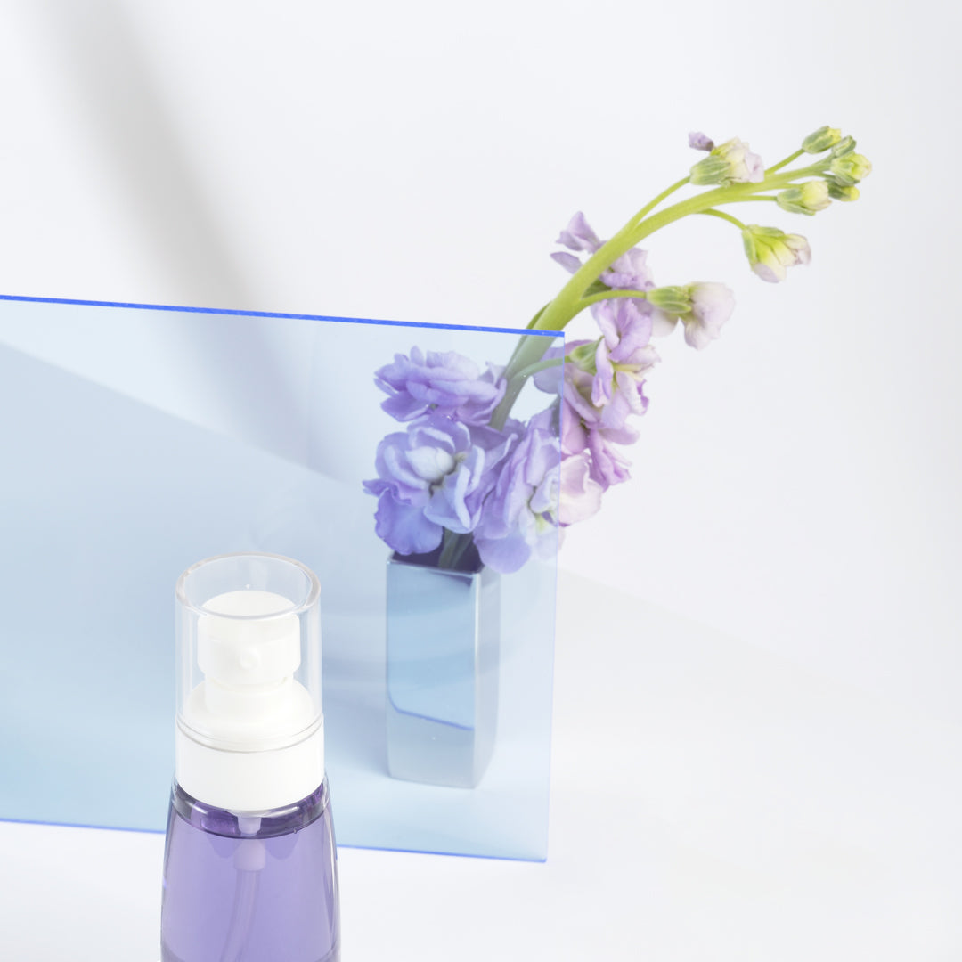 cosmetic product photography purple flowers acrylic blue prop